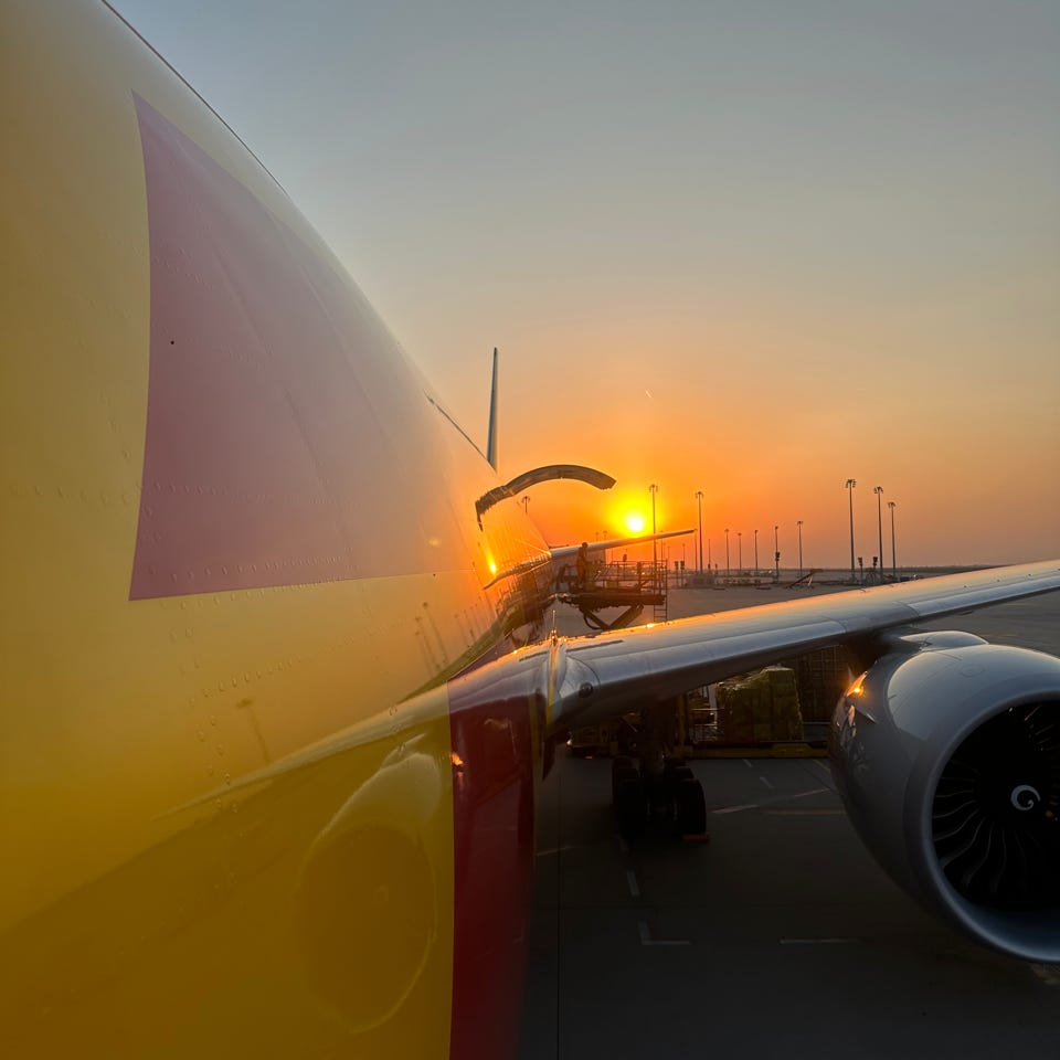 A DHL B777F at sunrise as taken from crew door